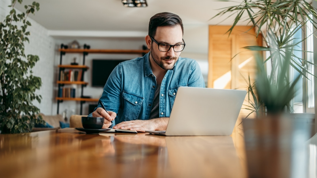 Tax reporting changes - Man working on his laptop from home.